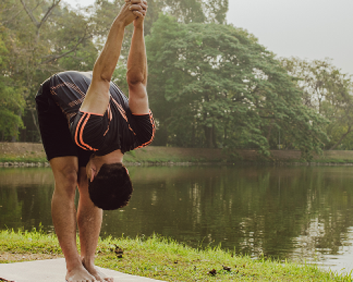 man-stretching-lake-nature